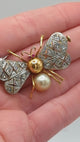 Bee brooch in gold with rubies and pearl