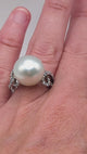 Large silver pearl ring with swirling diamond band