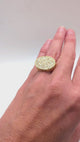 Oversized oval-shaped gold ring with pave diamonds